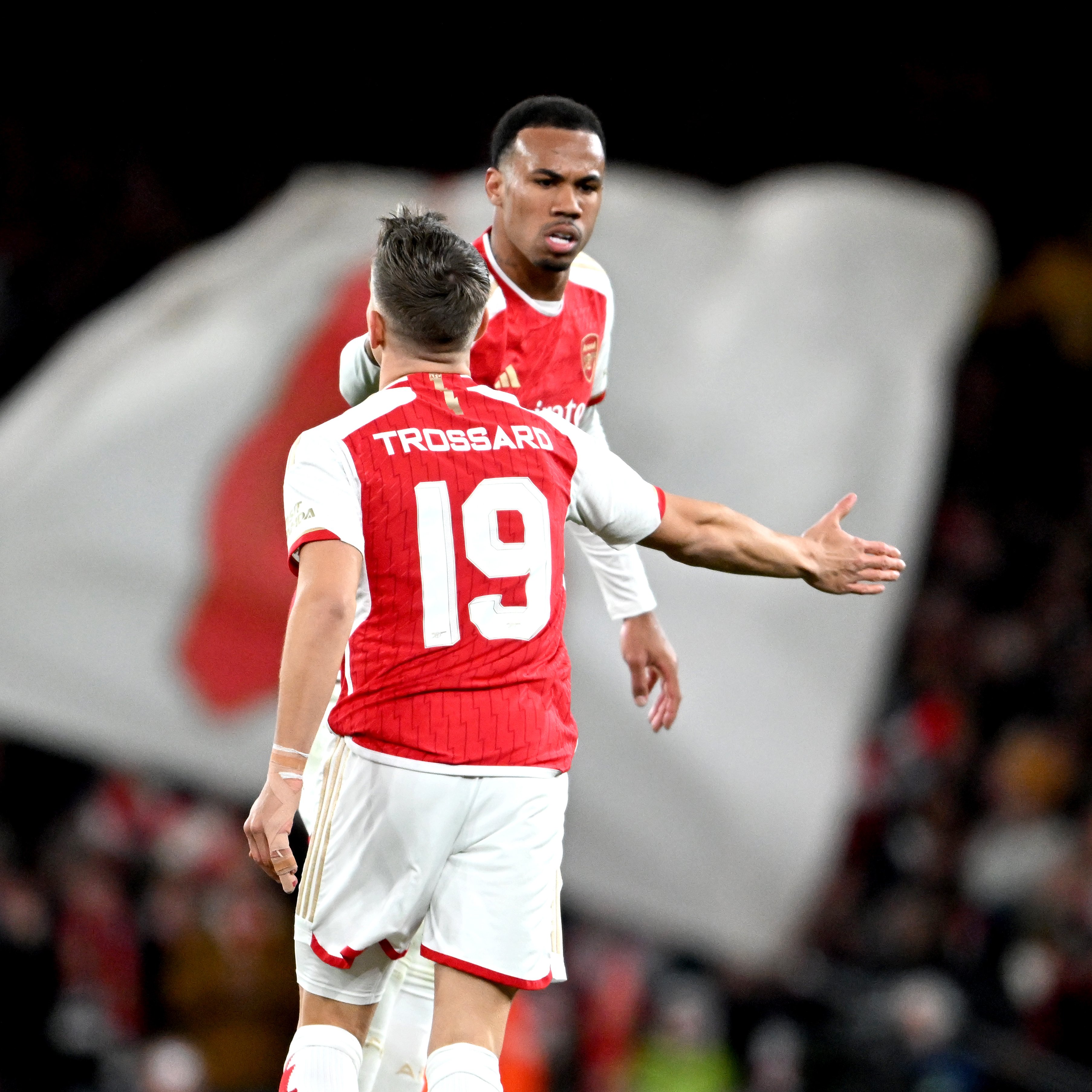 Leandro Trossard and Gabriel celebrate the former's goal.