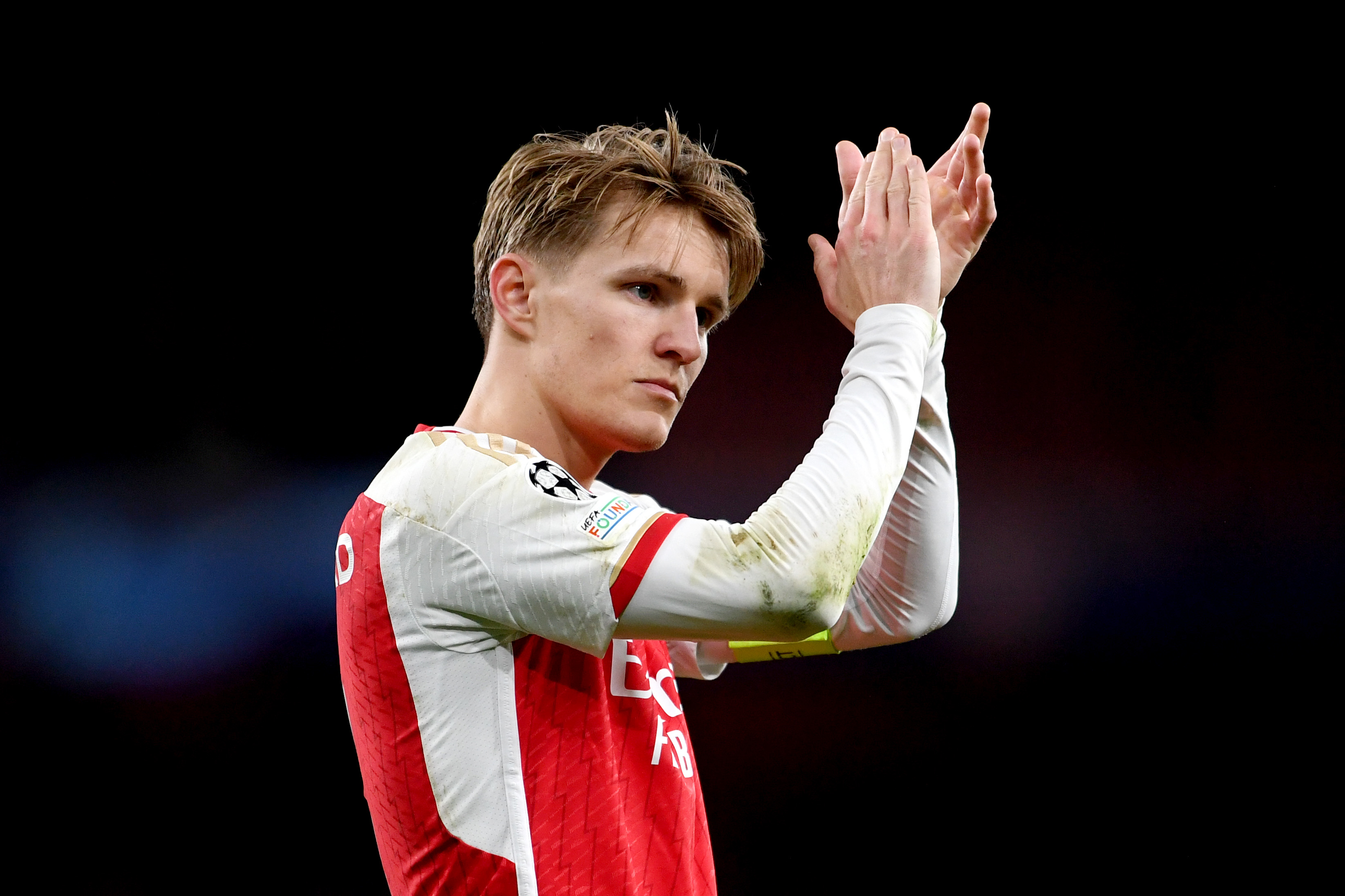 Martin Odegaard applauds the Arsenal crowd.