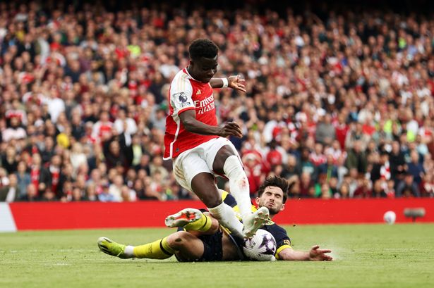 Bukayo Saka, who came in for some rough treatment against Bournemouth, a tackled by Lewis Cook