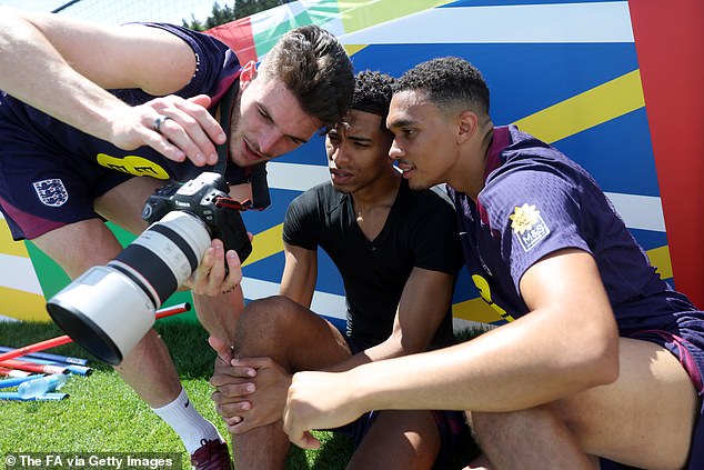 Rice shows team-mates Jude Bellingham and Trent Alexander-Arnold his pictures