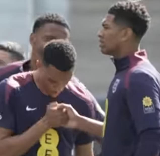 Bellingham and Alexander-Arnold were seen perfecting a new handshake in training, with Ezri Konsa watching on in the background