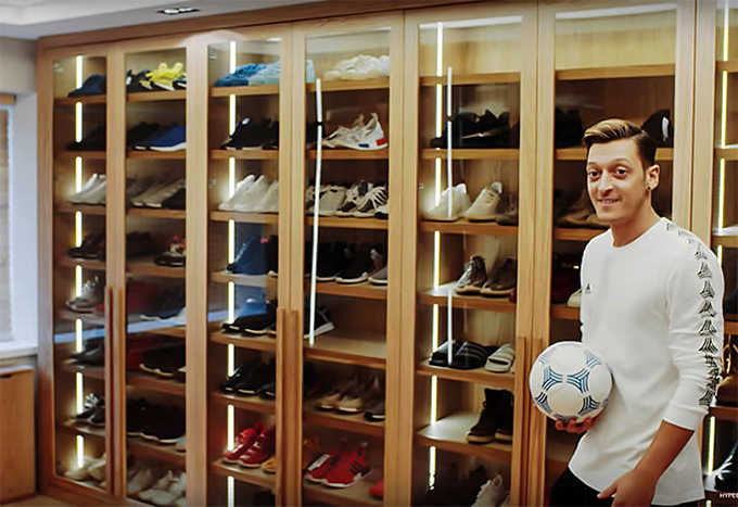 Changing room with hundreds of Ozil's shoes