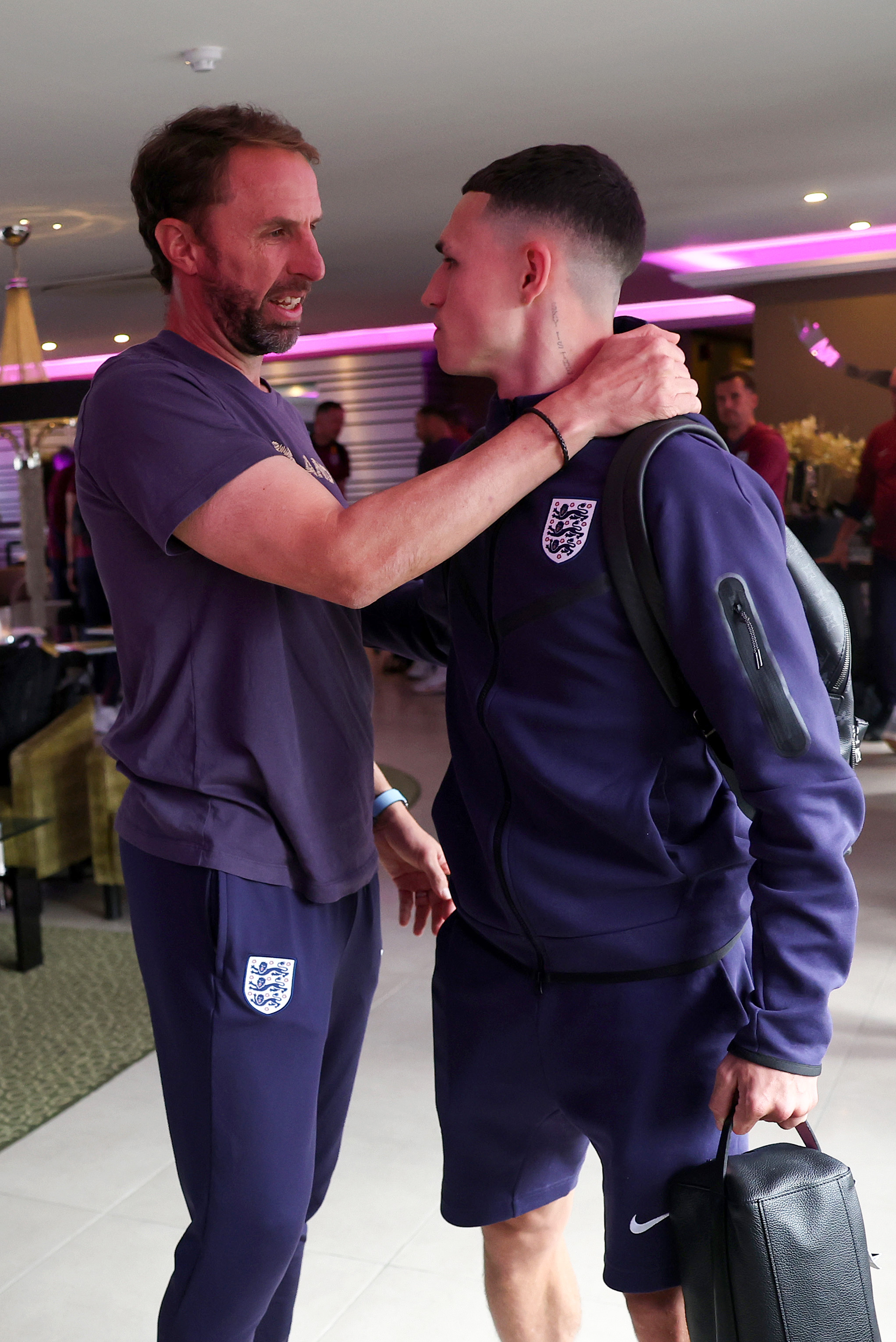 The England boss lovingly consoles Phil Foden as they depart camp