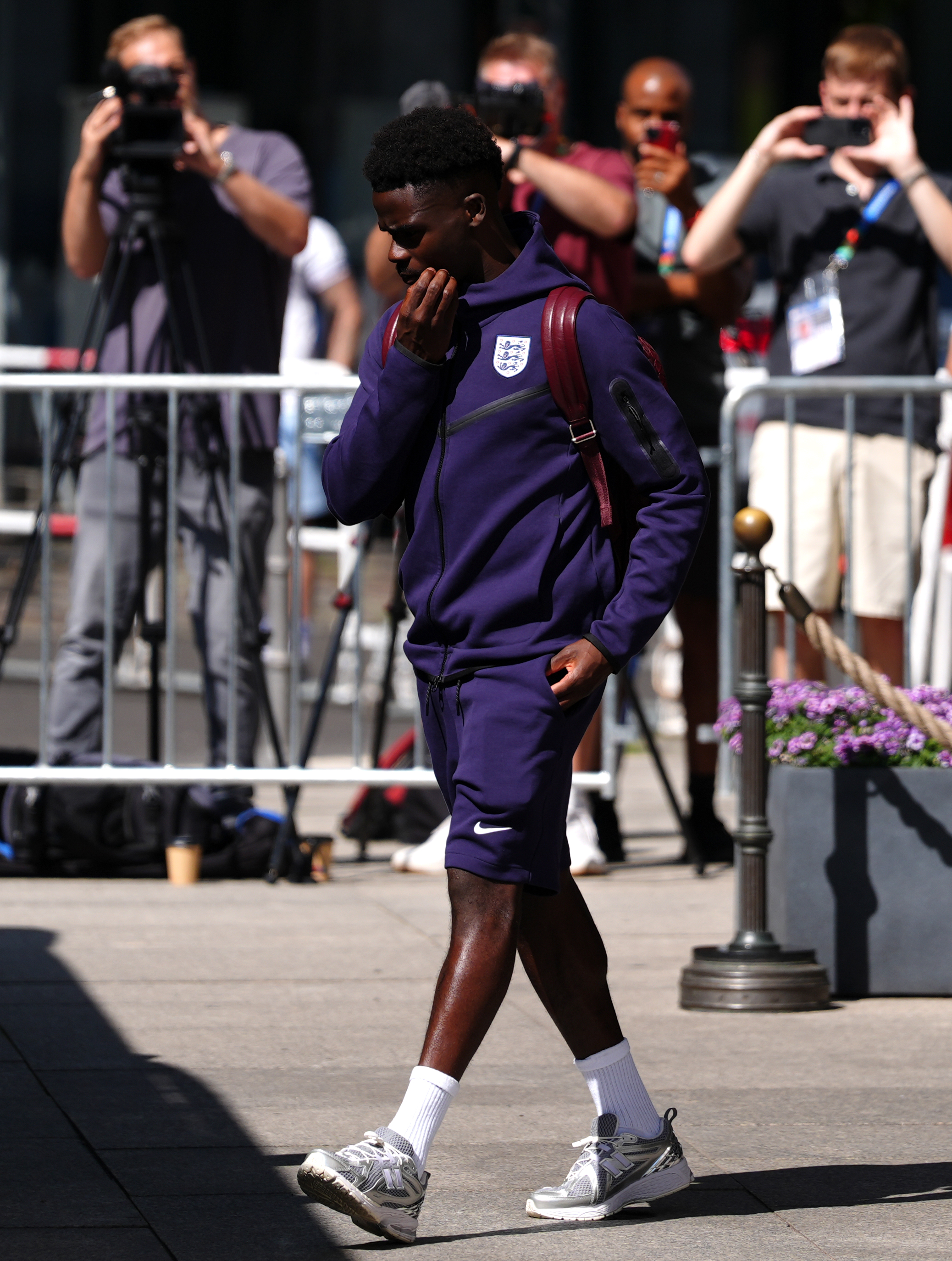 Saka looked down before boarding England's team bus in Berlin