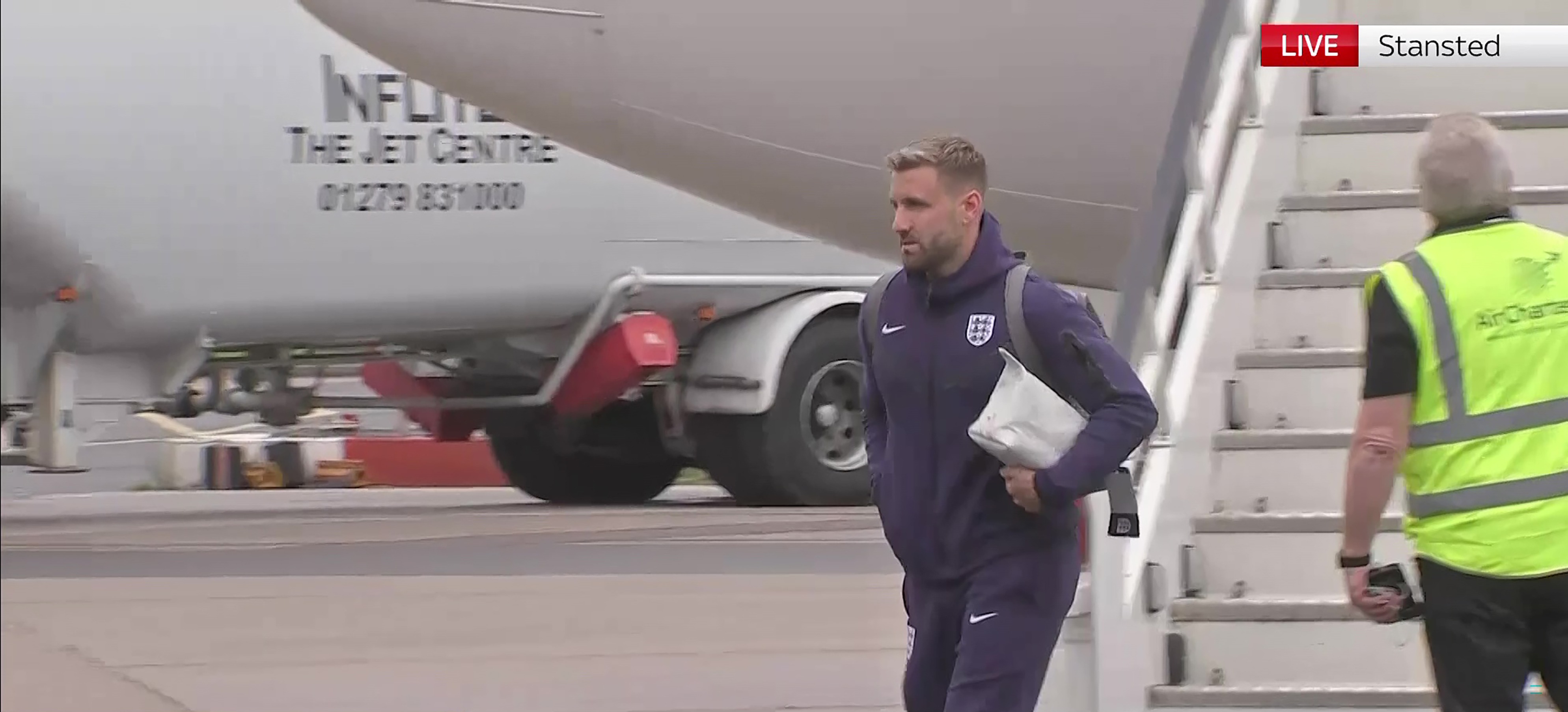 Luke Shaw looked glum as he made his way down the stairs