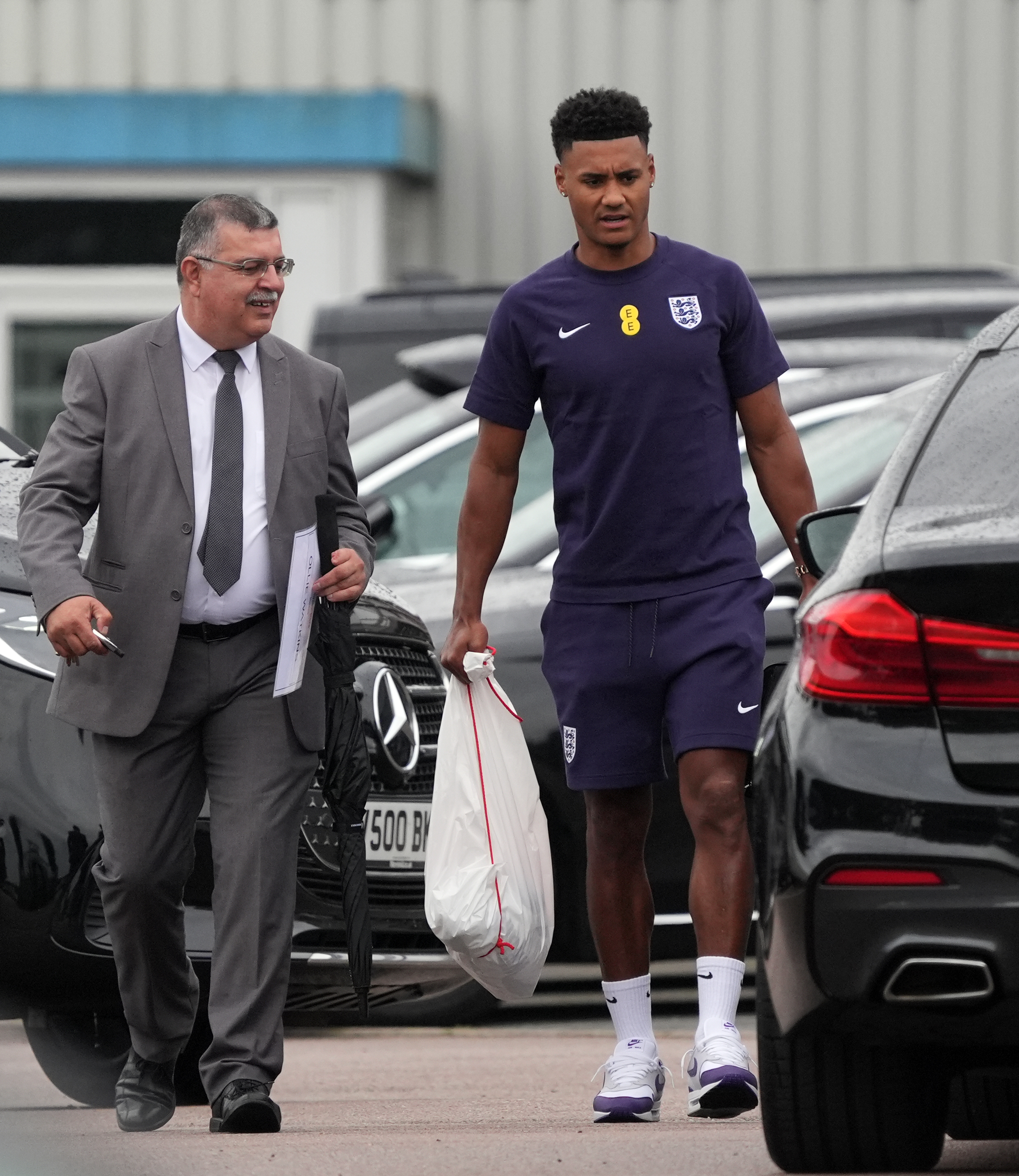 Ollie Watkins heads for the car home from Stansted Airport