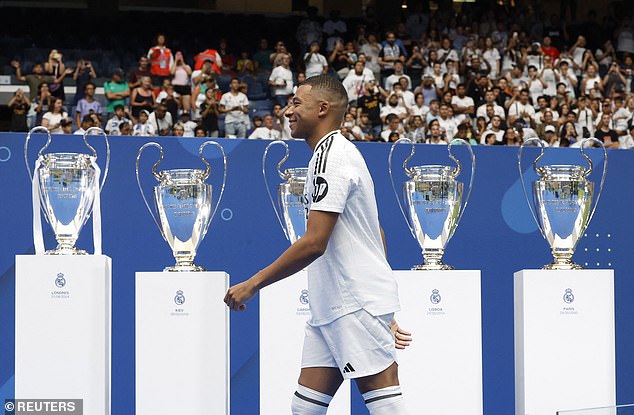 He walked past Real Madrid's 14 Champions League trophies as he took to the stage to speak