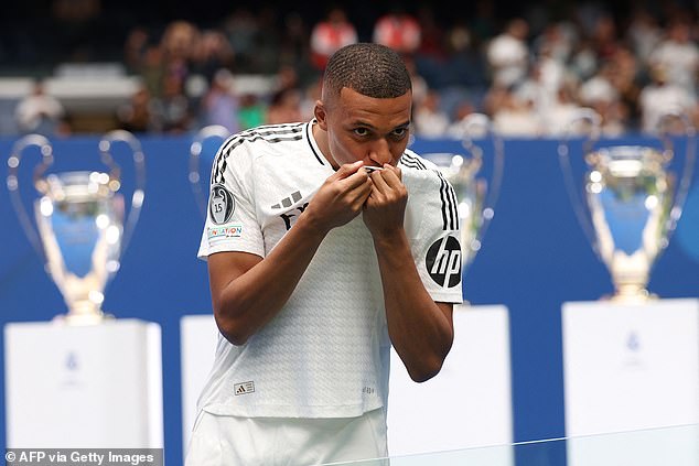 The new Madridista kissed his badge in front of the club's Champions League trophies as fans cheered